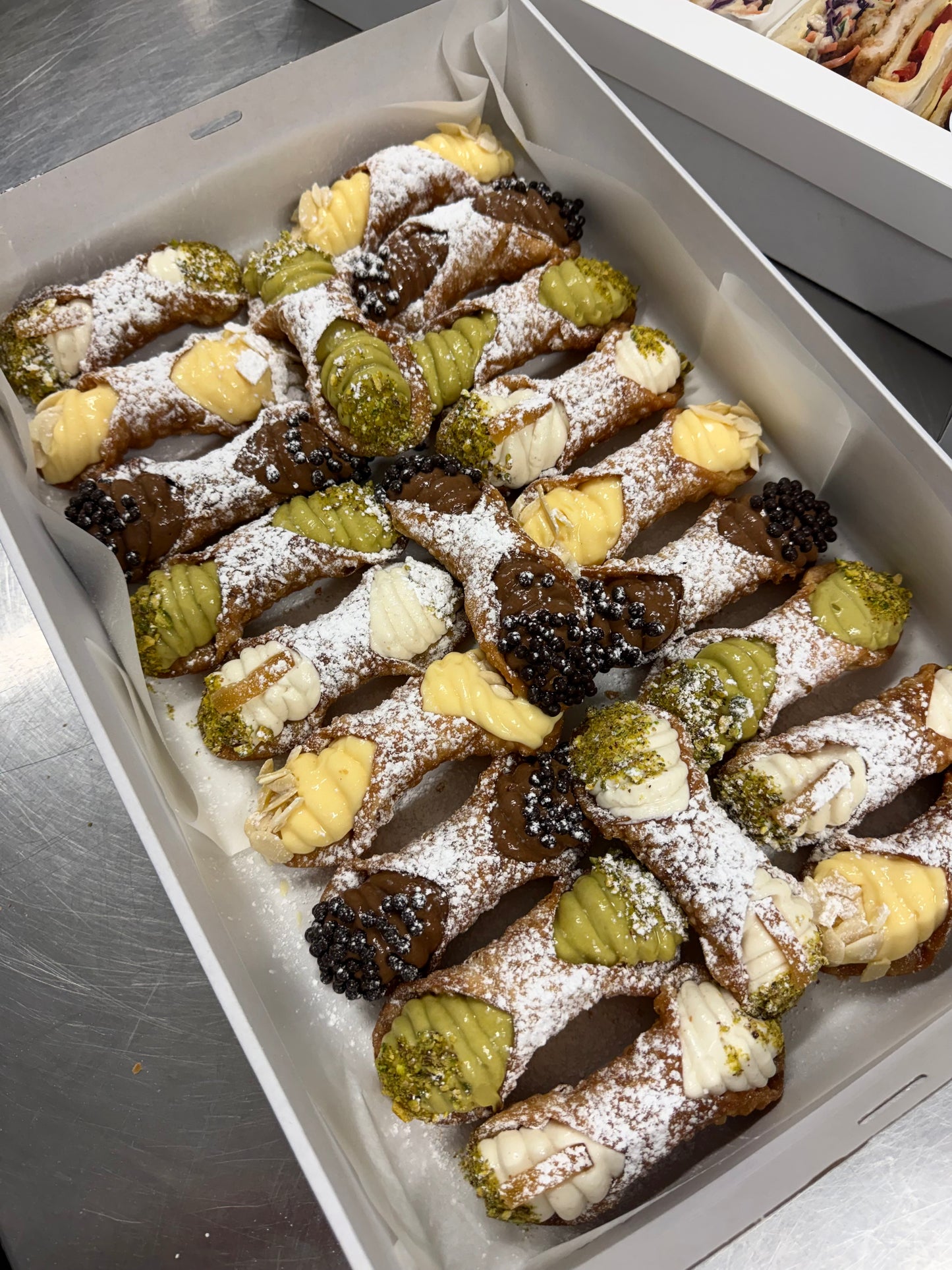 Hand-filled Italian cannoli with ricotta, vanilla, chocolate and pistachio fillings.