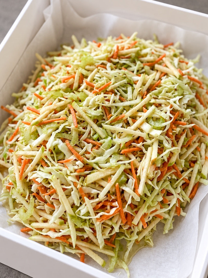 Fresh coleslaw presented in Cibo's white catering box